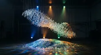 Stream of polyester fibre lit in a dark hall