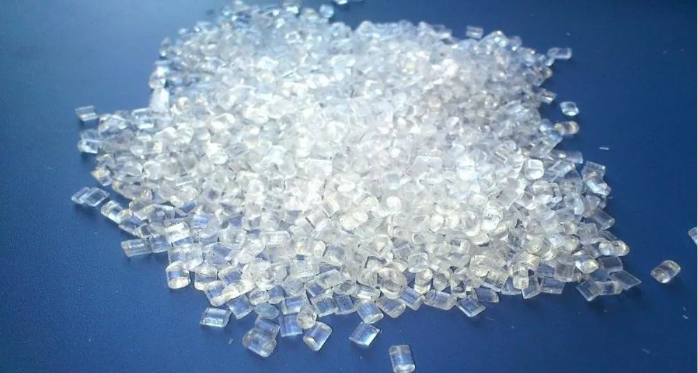 Clear polystyrene granules on a blue surface