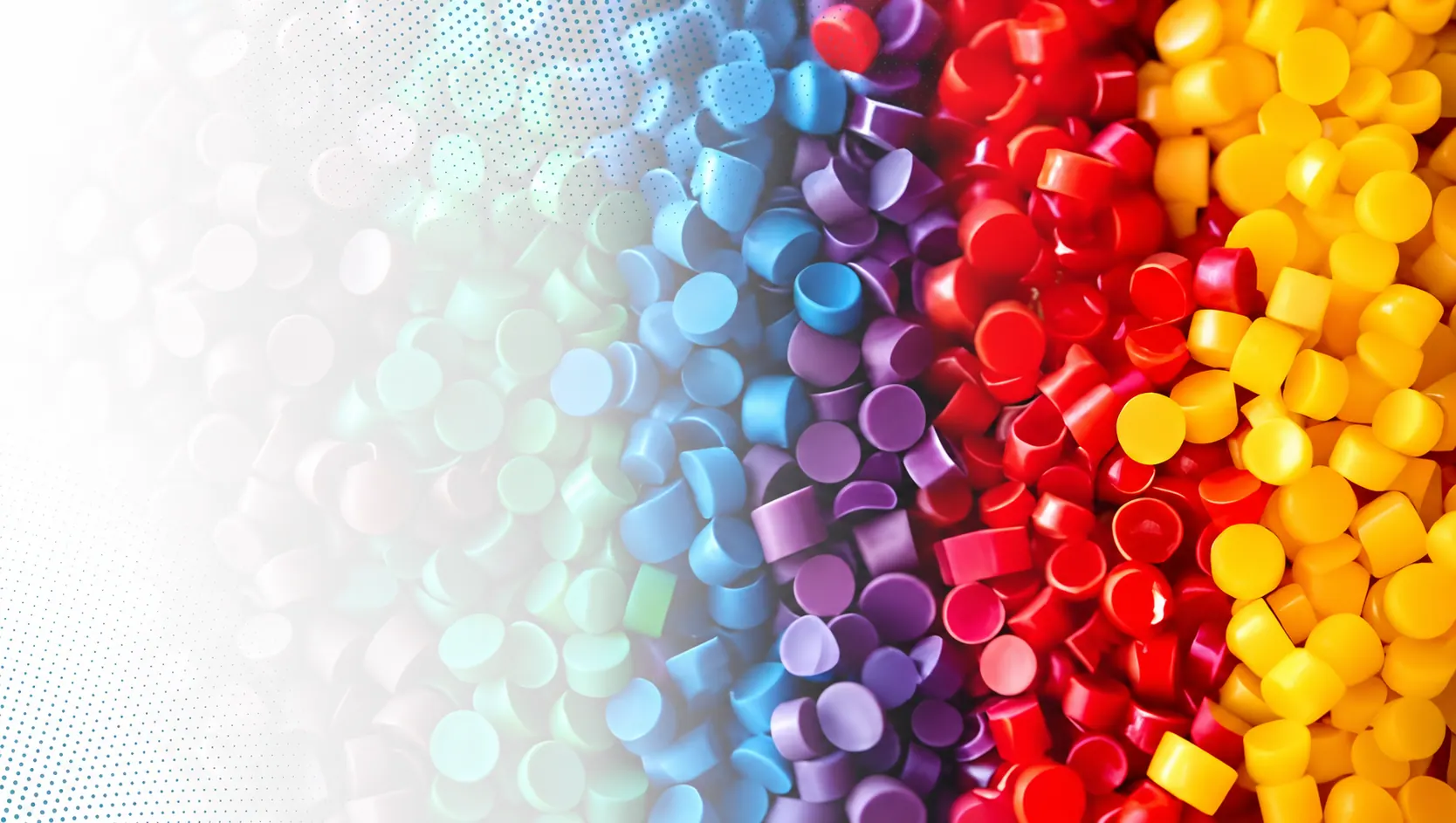 Polymer resin granules in a spectrum of colours, from clear to red, orange and yellow